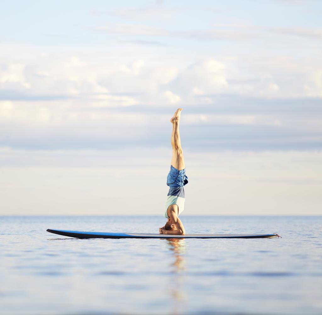 Man doing yoga on paddleboard
